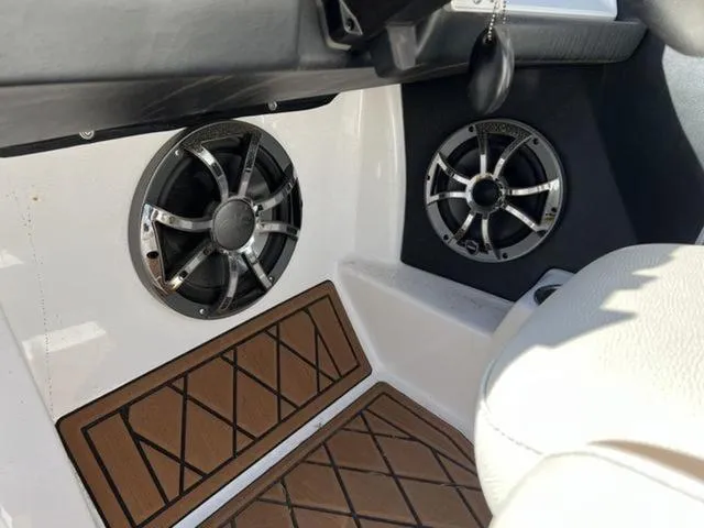 Slide: The Image of Interior of 2019 Tigé RZX2 boat featuring dual speakers and brown diamond-patterned flooring. - 14