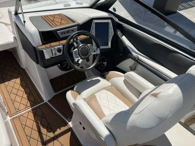 Slide: The Image of 2019 Tigé RZX2 boat interior with modern dashboard and luxurious seating. - 24