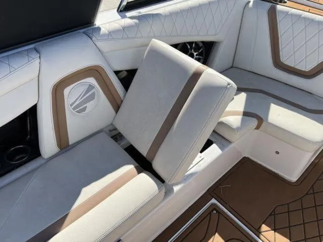 Slide: The Image of 2019 Tigé RZX2 boat interior with white and brown cushioned seating. - 26