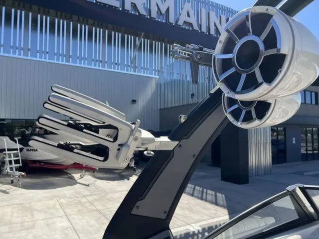 Slide: The Image of 2019 Tigé RZX2 boat with tower speakers and wakeboard racks, outdoor showroom display. - 27