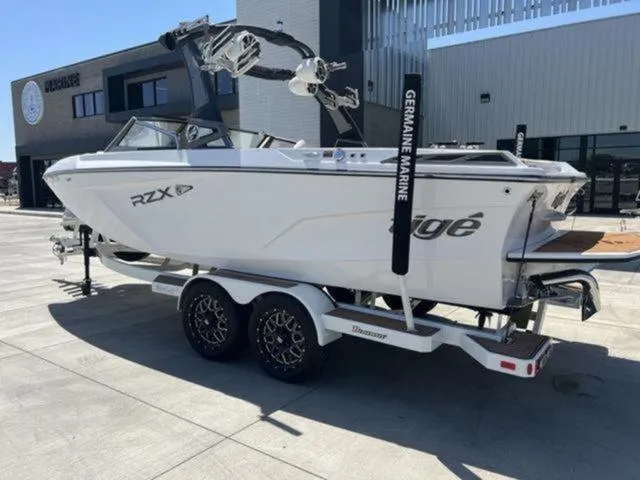 Slide: The Image of 2019 Tigé RZX2 boat on trailer outside a modern building. - 34