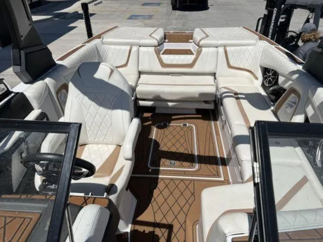 Slide: The Image of 2019 Tigé RZX2 boat interior with luxurious white and tan seating. - 38