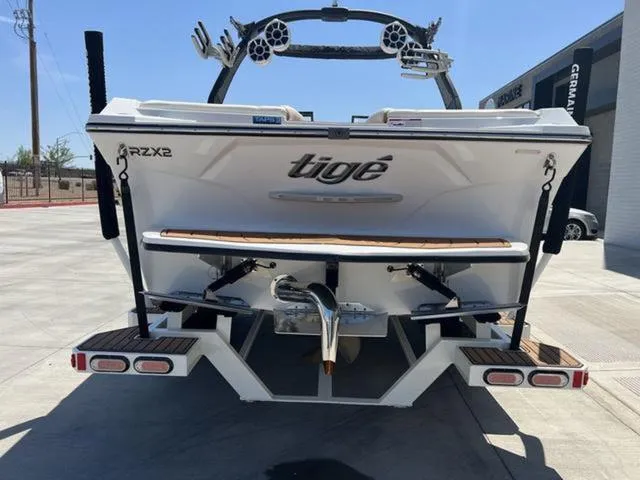 Slide: The Image of 2019 Tigé RZX2 boat rear view, showcasing sleek design and wakeboard tower. - 5