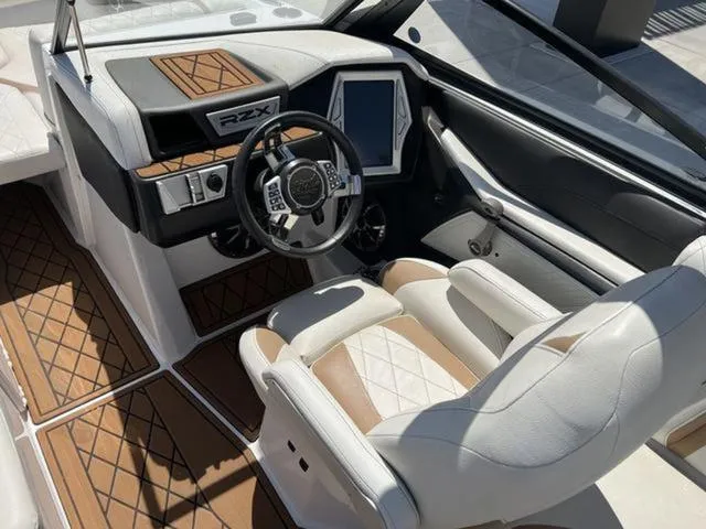 Slide: The Image of 2019 Tigé RZX2 boat interior with modern dashboard and luxurious seating. - 8