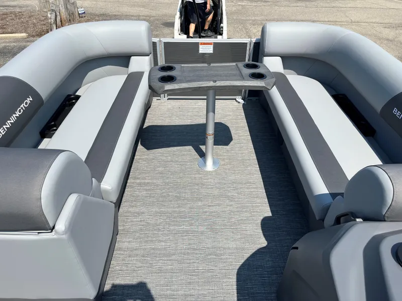 Slide: The Image of 2024 Bennington SV Line boat interior with gray seating and central table. - 9