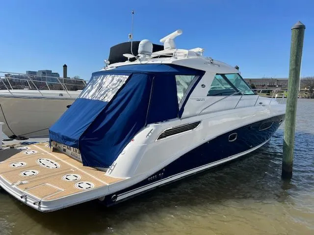 Slide: The Image of 2010 Sea Ray 450 Sundancer yacht docked with blue canvas cover. - 0