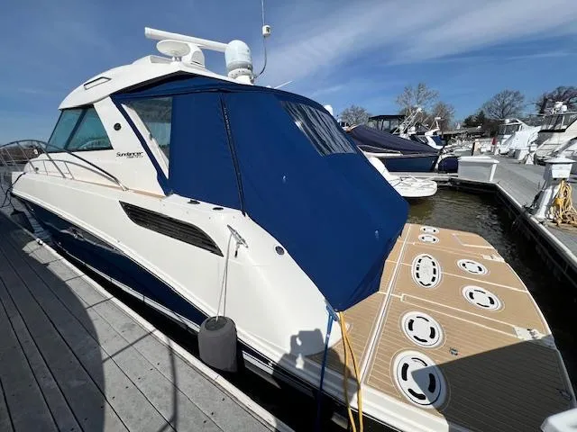 Slide: The Image of 2010 Sea Ray 450 Sundancer yacht docked at marina with blue canopy. - 1