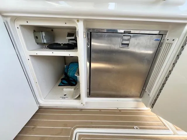 Slide: The Image of Storage compartments and stainless steel fridge on 2010 Sea Ray 450 Sundancer yacht. - 10