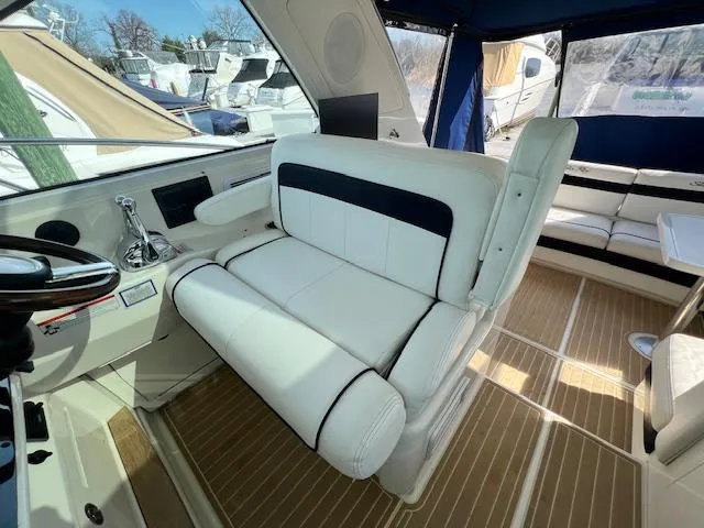 Slide: The Image of Interior helm seating of 2010 Sea Ray 450 Sundancer yacht with white leather upholstery. - 12