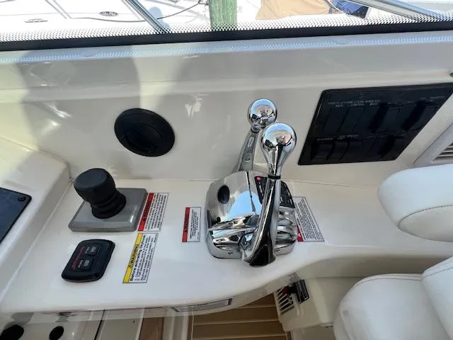 Slide: The Image of Control panel of a 2010 Sea Ray 450 Sundancer yacht with throttle and joystick. - 14