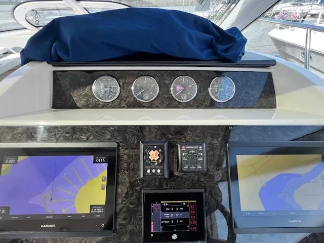 Slide: The Image of Dashboard of a 2010 Sea Ray 450 Sundancer with navigation screens and gauges. - 20