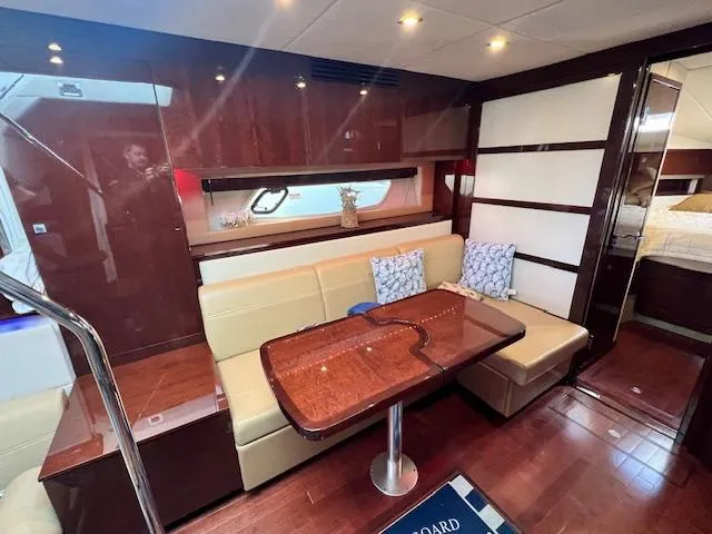 Slide: The Image of Luxurious interior of 2010 Sea Ray 450 Sundancer yacht with dining area and modern decor. - 26