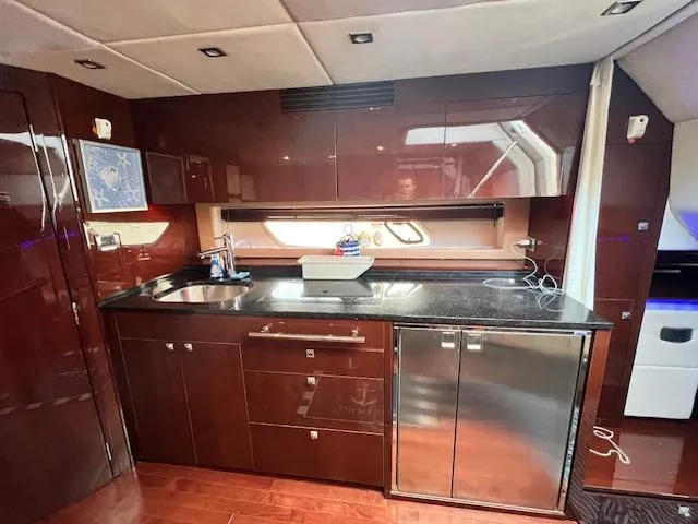 Slide: The Image of Luxurious kitchen area in 2010 Sea Ray 450 Sundancer yacht with modern amenities. - 27