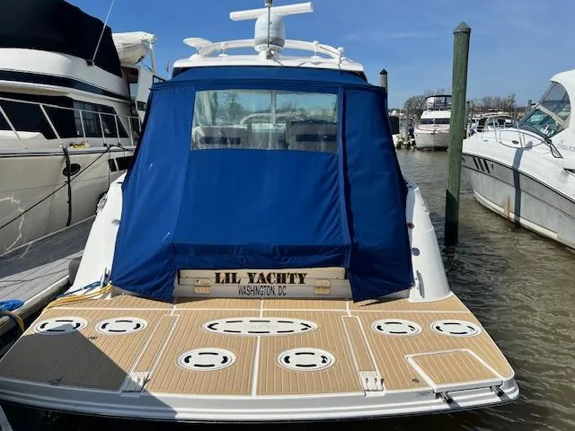 Slide: The Image of Sea Ray 450 Sundancer 2010 docked, rear view with blue cover, named Lil Yachty. - 3