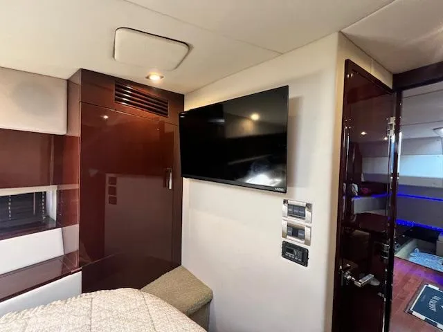 Slide: The Image of Interior cabin of 2010 Sea Ray 450 Sundancer with TV and control panels. - 30