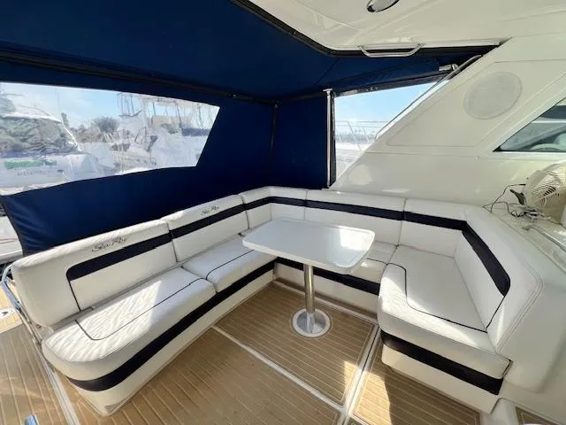 Slide: The Image of Interior seating area of 2010 Sea Ray 450 Sundancer yacht with white and navy upholstery. - 5
