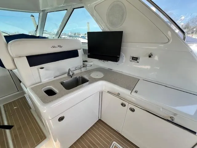 Slide: The Image of Interior of 2010 Sea Ray 450 Sundancer yacht with kitchenette and TV. - 9