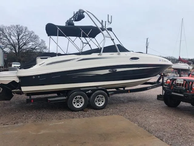The Image of 2010 Sea Ray 260 Sun Deck boat on a trailer, side view. - 0