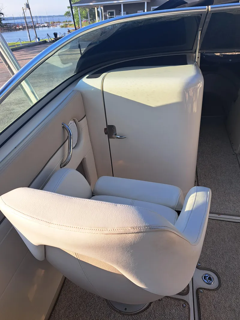 Slide: The Image of 2010 Sea Ray 260 Sun Deck boat interior with beige seating and storage compartment. - 12