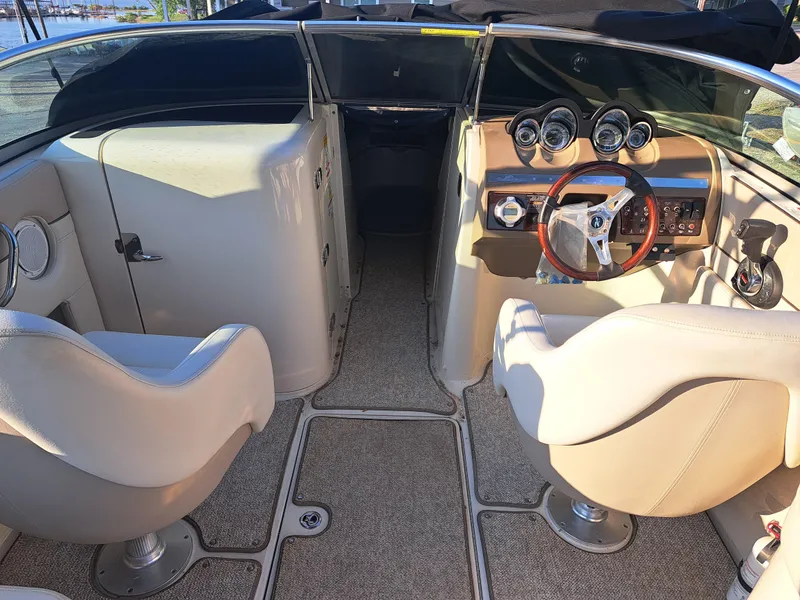 Slide: The Image of 2010 Sea Ray 260 Sun Deck boat interior with helm and seating. - 14