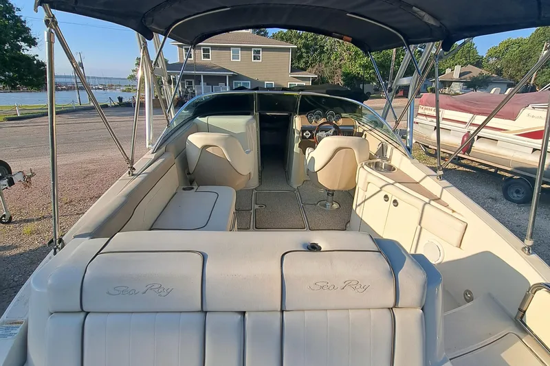 Slide: The Image of 2010 Sea Ray 260 Sun Deck boat interior with seating and steering wheel. - 16