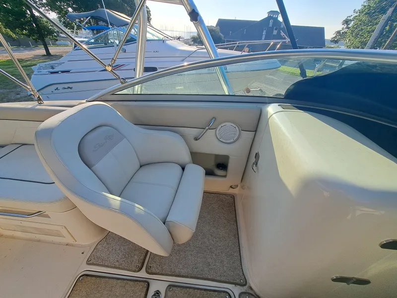 Slide: The Image of 2010 Sea Ray 260 Sun Deck interior with beige seating and dashboard. - 18