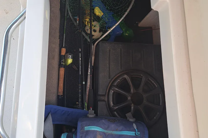 Slide: The Image of Storage compartment of a 2010 Sea Ray 260 Sun Deck with fishing gear. - 20