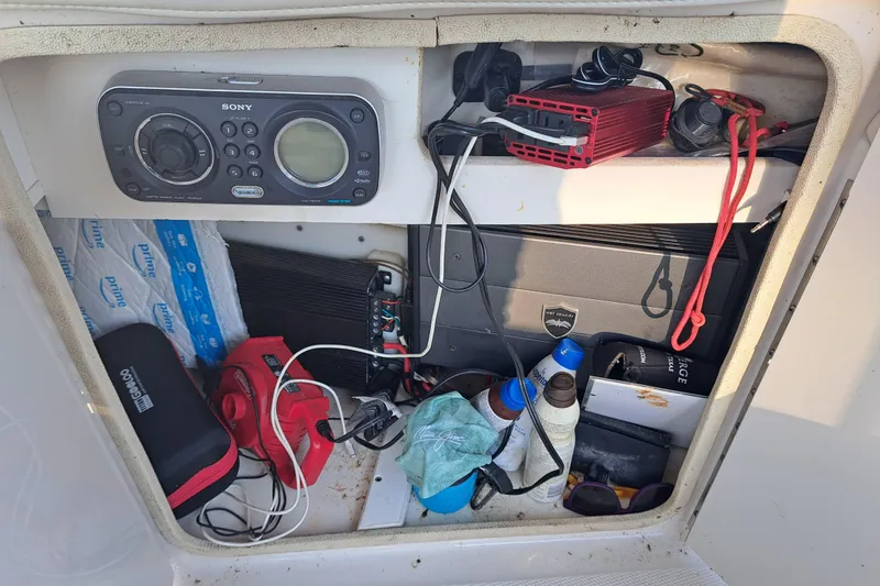 Slide: The Image of Storage compartment of a 2010 Sea Ray 260 Sun Deck with electronics and accessories. - 22