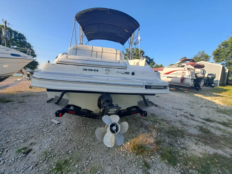 Slide: The Image of 2010 Sea Ray 260 Sun Deck boat with canopy, rear view on gravel lot. - 3