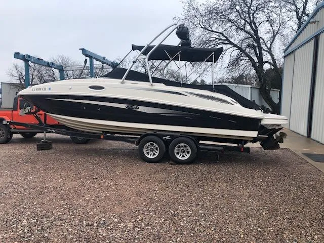 Slide: The Image of 2010 Sea Ray 260 Sun Deck boat on a trailer in a yard. - 4
