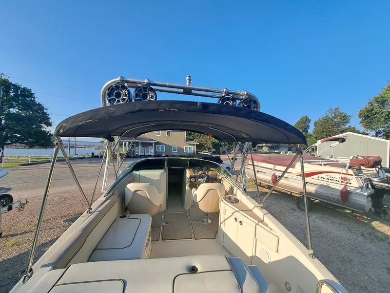 Slide: The Image of 2010 Sea Ray 260 Sun Deck boat with canopy and seating area. - 5