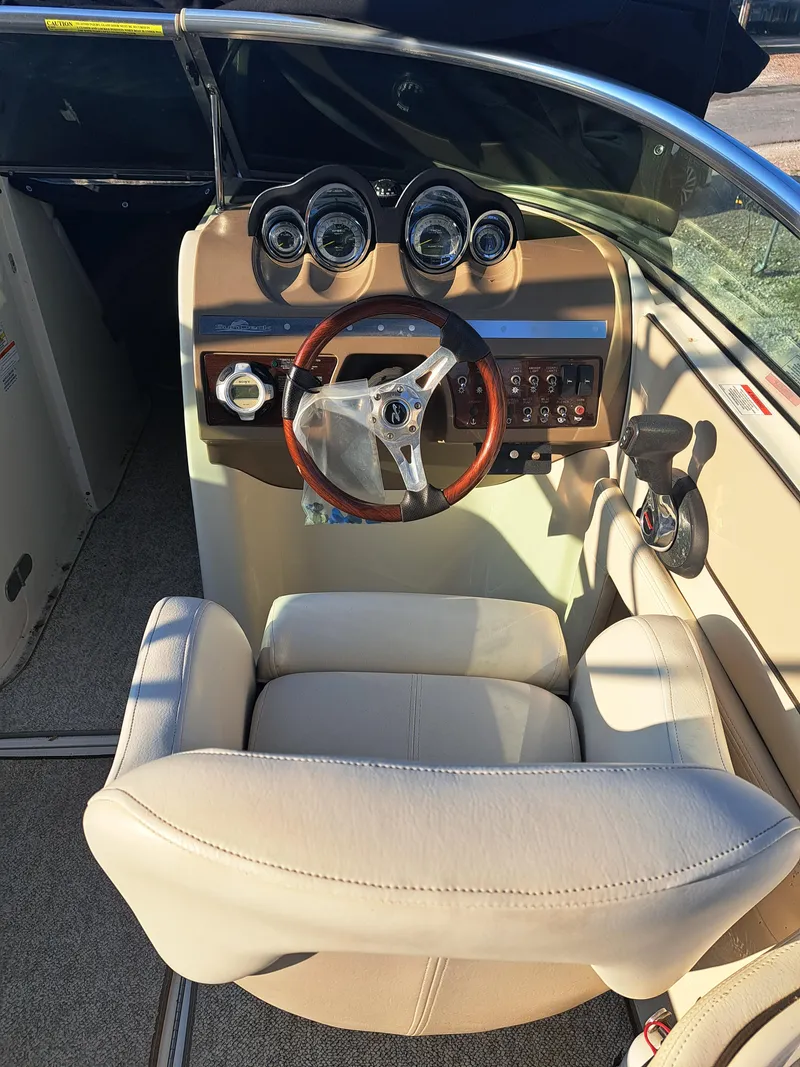 Slide: The Image of 2010 Sea Ray 260 Sun Deck boat cockpit with steering wheel and gauges. - 6