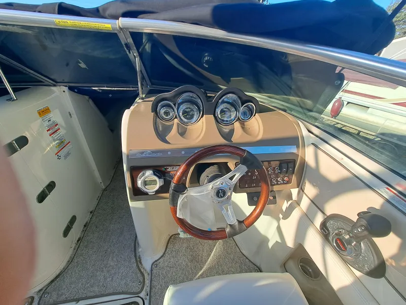 Slide: The Image of 2010 Sea Ray 260 Sun Deck boat cockpit with steering wheel and instrument panel. - 7
