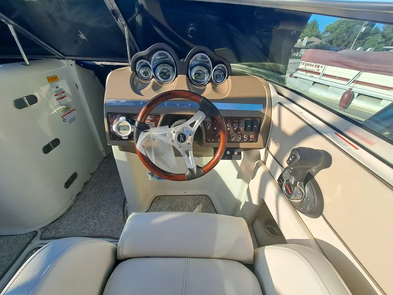 Slide: The Image of 2010 Sea Ray 260 Sun Deck boat cockpit with steering wheel and control panel. - 8