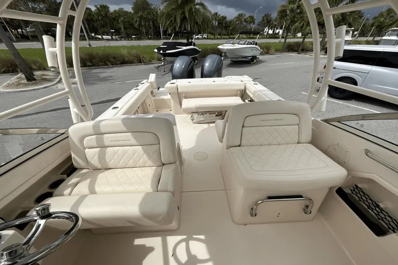 Slide: The Image of 2023 Grady-White Freedom 275 boat interior with plush seating and steering wheel. - 10