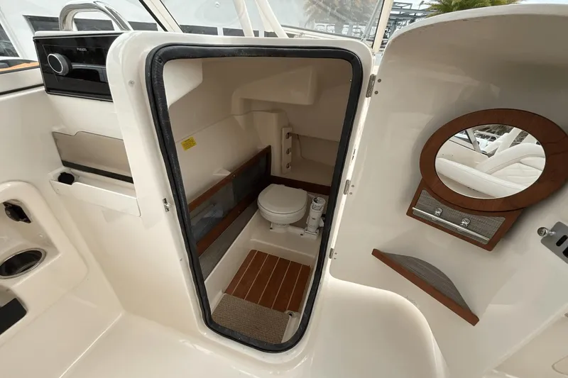 Slide: The Image of 2023 Grady-White Freedom 275 boat interior with compact bathroom and mirror. - 12