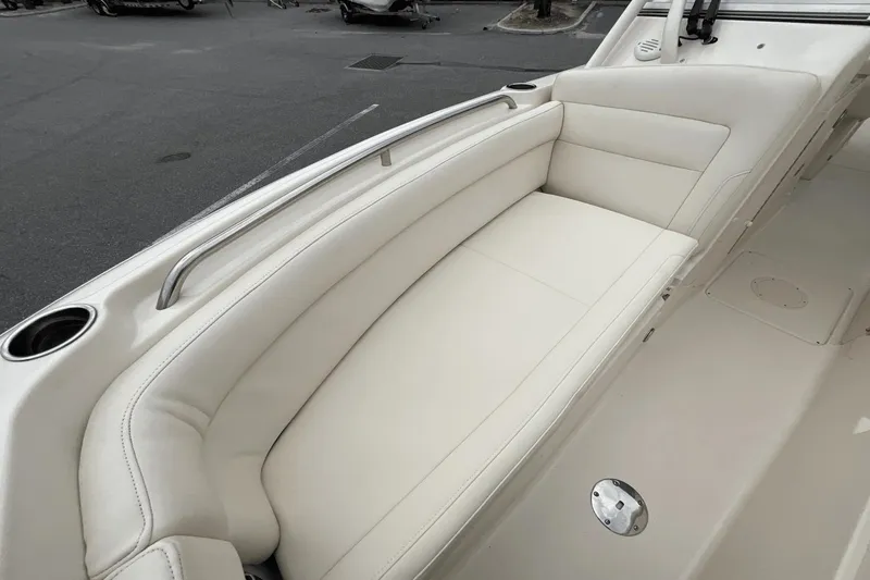 Slide: The Image of 2023 Grady-White Freedom 275 boat interior with white cushioned seating. - 14