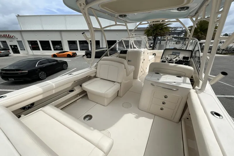 Slide: The Image of 2023 Grady-White Freedom 275 boat interior with luxurious seating and modern dashboard. - 18