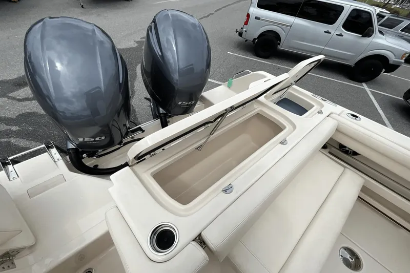 Slide: The Image of 2023 Grady-White Freedom 275 boat with dual Yamaha 150 engines in a parking lot. - 20