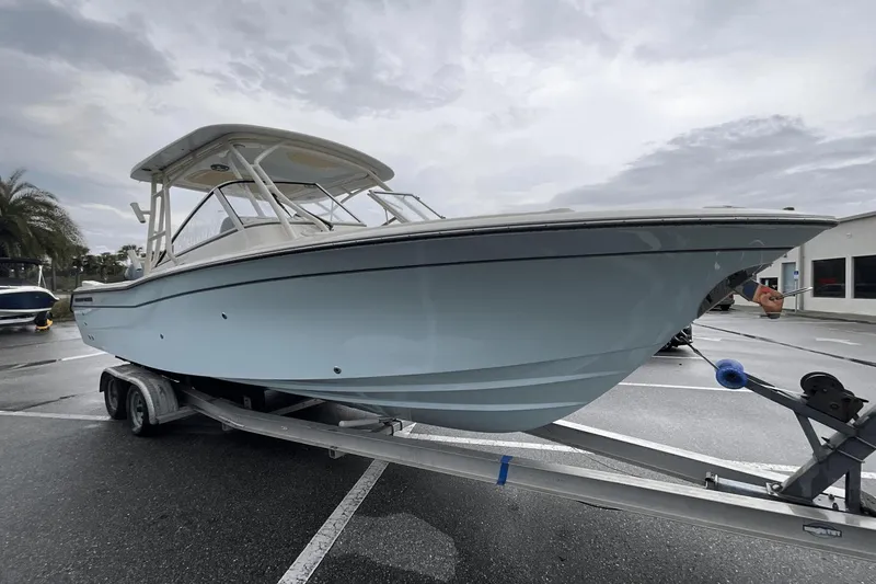 Slide: The Image of 2023 Grady-White Freedom 275 boat on trailer in parking lot. - 3