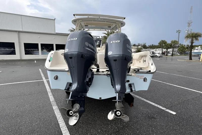 Slide: The Image of 2023 Grady-White Freedom 275 boat with dual Yamaha 150 engines in a parking lot. - 5