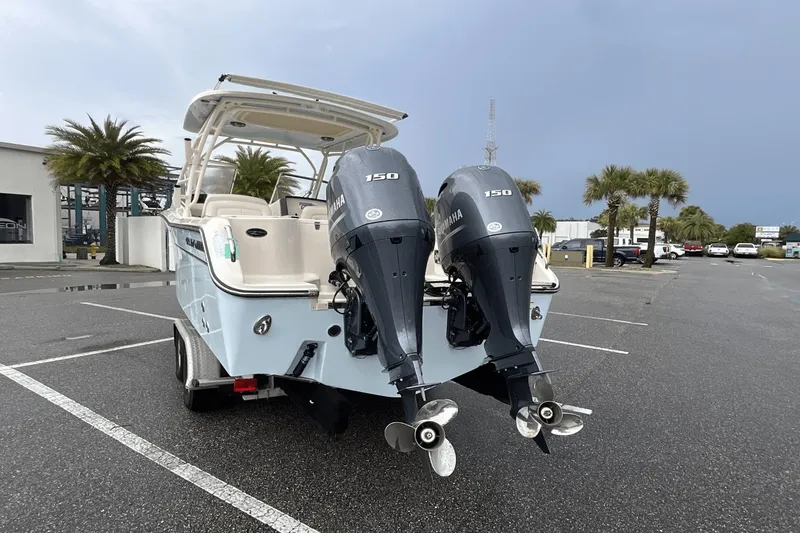 Slide: The Image of 2023 Grady-White Freedom 275 boat with dual Yamaha 150 engines in a parking lot. - 6