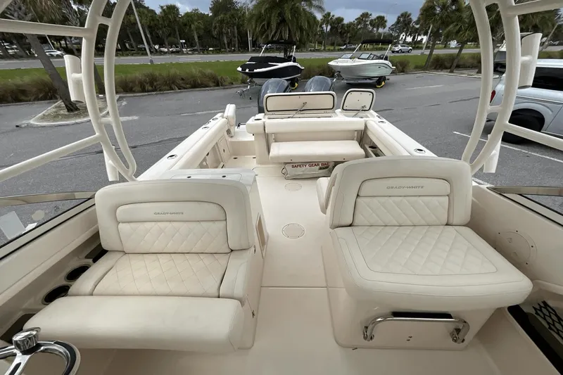 Slide: The Image of 2023 Grady-White Freedom 275 boat interior with plush seating and safety gear bag. - 9