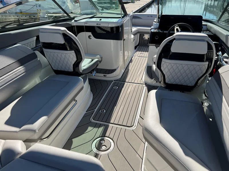 Slide: The Image of 2023 Sea Ray SLX 260 Outboard interior with luxurious seating and modern design. - 10