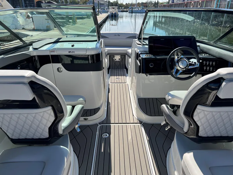 Slide: The Image of 2023 Sea Ray SLX 260 Outboard interior with modern helm and luxurious seating. - 11
