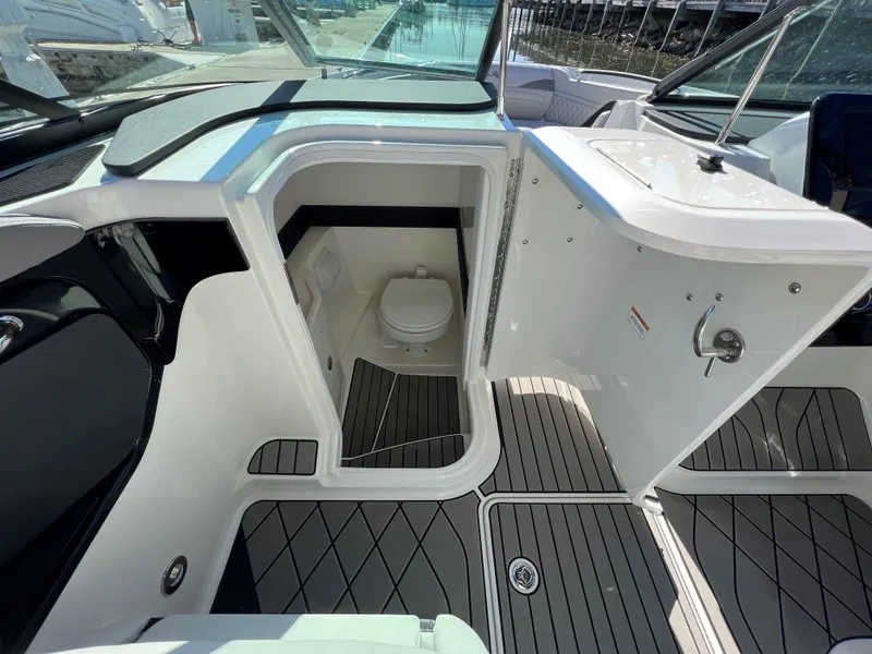 Slide: The Image of 2023 Sea Ray SLX 260 Outboard boat interior with open bathroom door. - 13