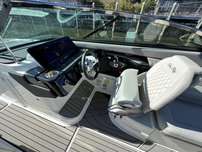 Slide: The Image of 2023 Sea Ray SLX 260 Outboard cockpit with modern dashboard and luxurious seating. - 15