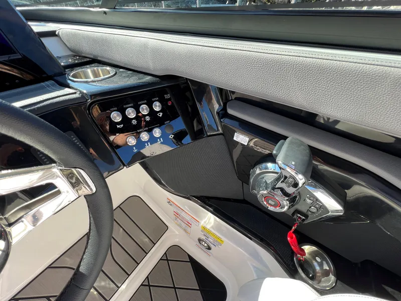 Slide: The Image of 2023 Sea Ray SLX 260 Outboard helm with modern controls and sleek design. - 16