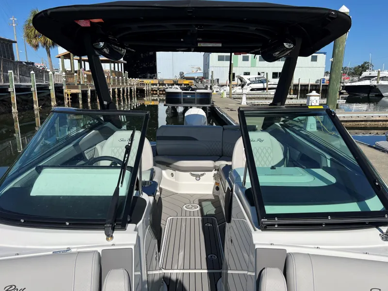 Slide: The Image of 2023 Sea Ray SLX 260 Outboard boat interior at a marina dock. - 19