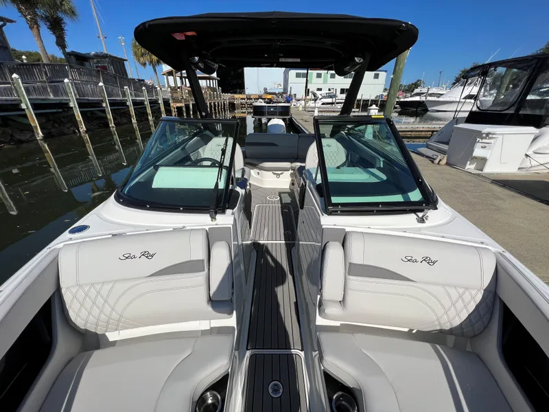 Slide: The Image of 2023 Sea Ray SLX 260 Outboard boat interior at marina, featuring luxurious seating and sleek design. - 20